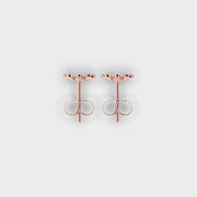 Rose gold earrings on a light gray background